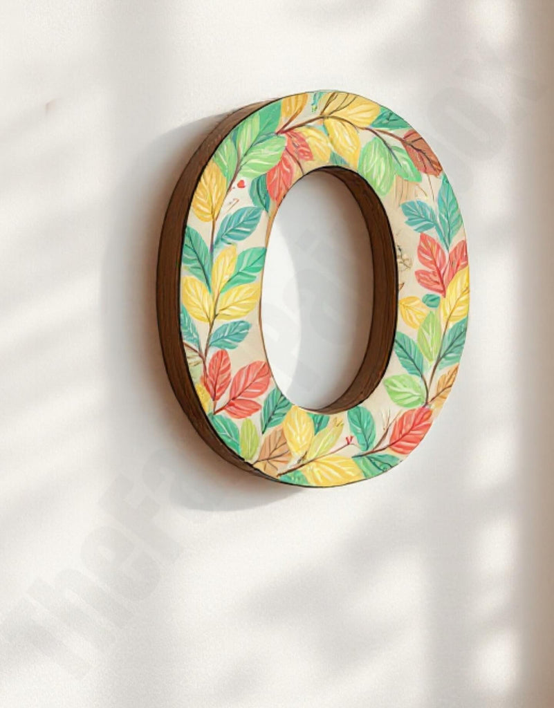 Decorative letter 'O' with a colorful leaf pattern on a white background
