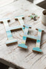 Beach house monogram letters sitting on a table.