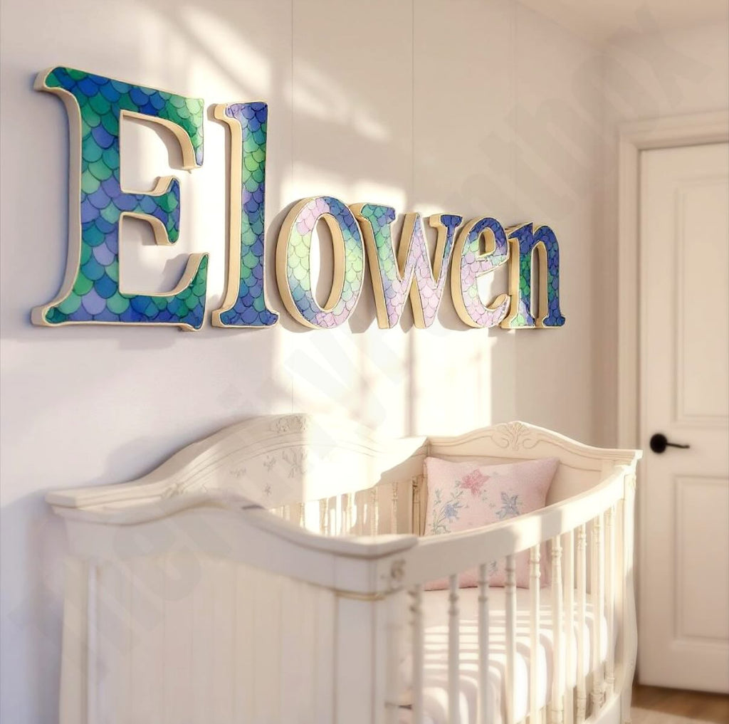 Decorative baby name sign hanging above a crib in a baby's fantasy themed room.